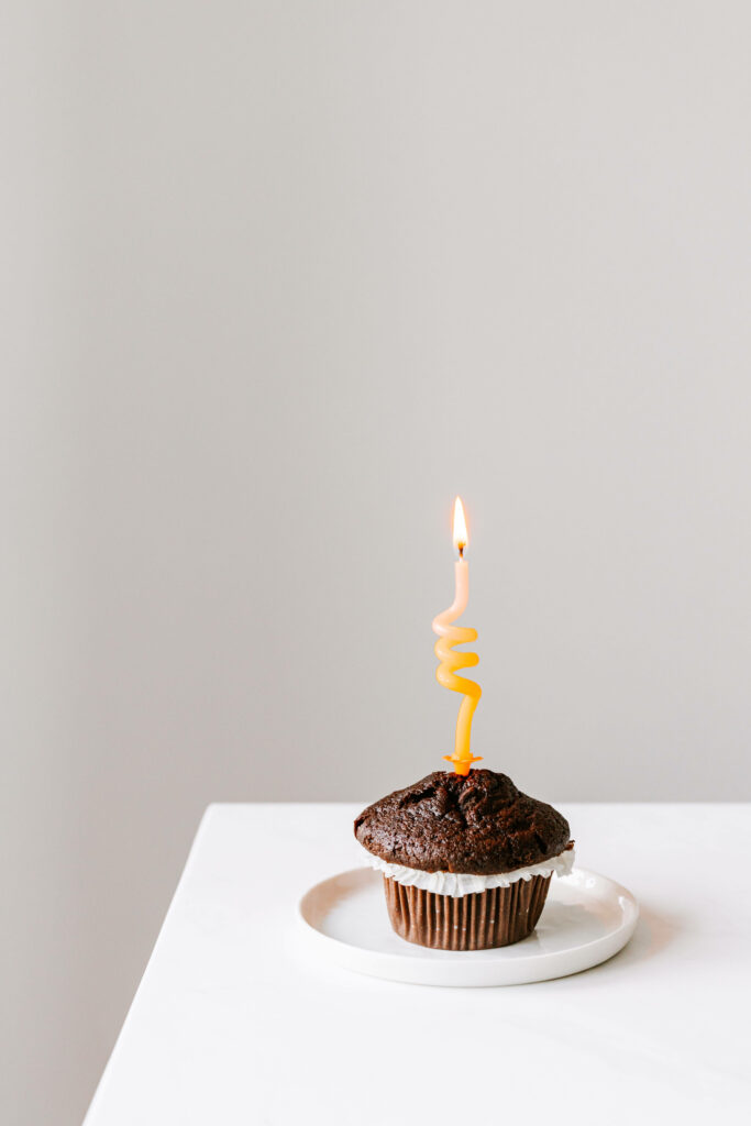 Delightful Chocolate Cupcake with Candle on Minimalist Background Wallpaper