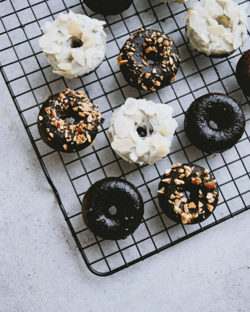 Delicious Chocolate Donuts with Icing & Nuts - Sweet Wallpaper Background