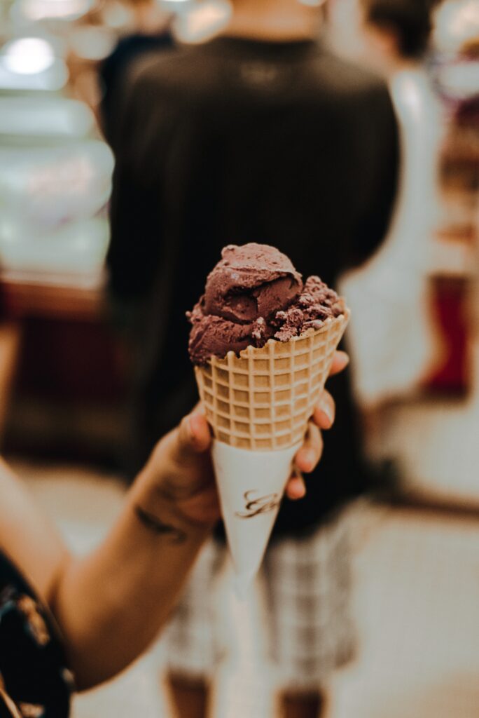 Indulge in Creamy Chocolate Ice Cream in Waffle Cone Wallpaper