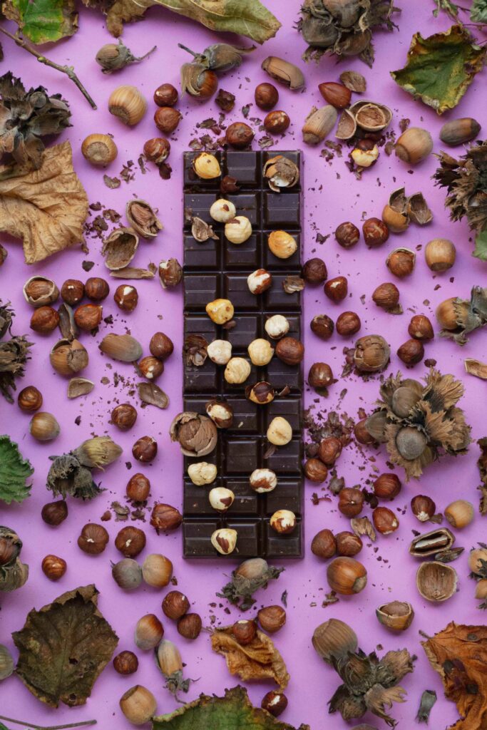 Delicious Chocolate & Nuts Wallpaper: Sweet Pink Background Decor