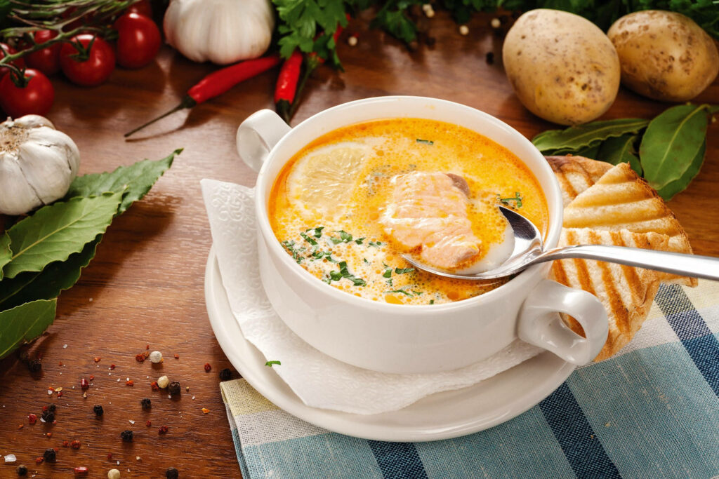 Chunky Fish Soup in White Bowl: Hearty Meal with Fresh Ingredients Wallpaper