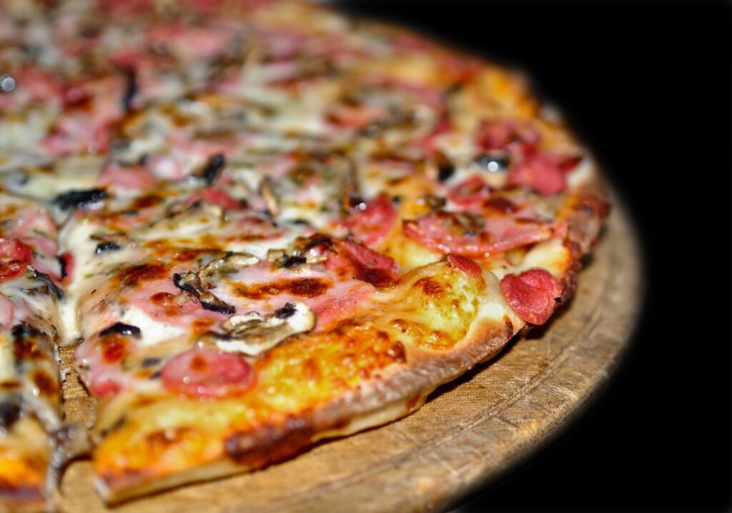 Close-Up of Delicious Pizza: Melted Cheese & Savory Toppings Wallpaper