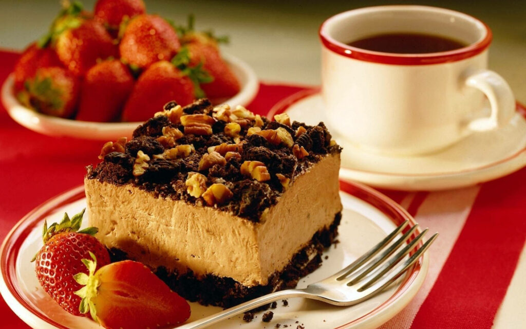 Delicious Coffee Cake Slice with Nuts, Chocolate & Strawberries Wallpaper