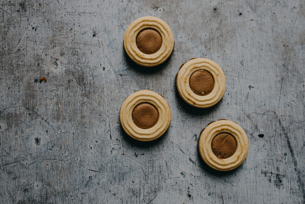 Delicious Cream-Filled Cookies: Rustic Dessert Wallpaper Background