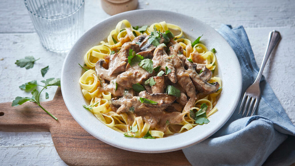 Delicious Beef Stroganoff Over Pasta with Parsley - Rustic Wallpaper