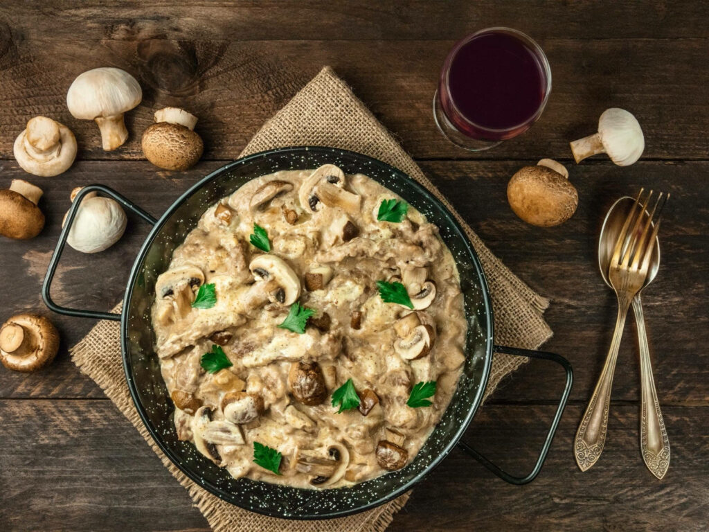 Delicious Creamy Beef Stroganoff with Mushrooms - Rustic Table Setting Wallpaper