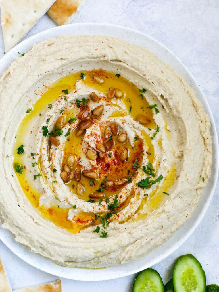 Elegant Creamy Hummus Close-Up with Olive Oil & Fresh Veggies Wallpaper