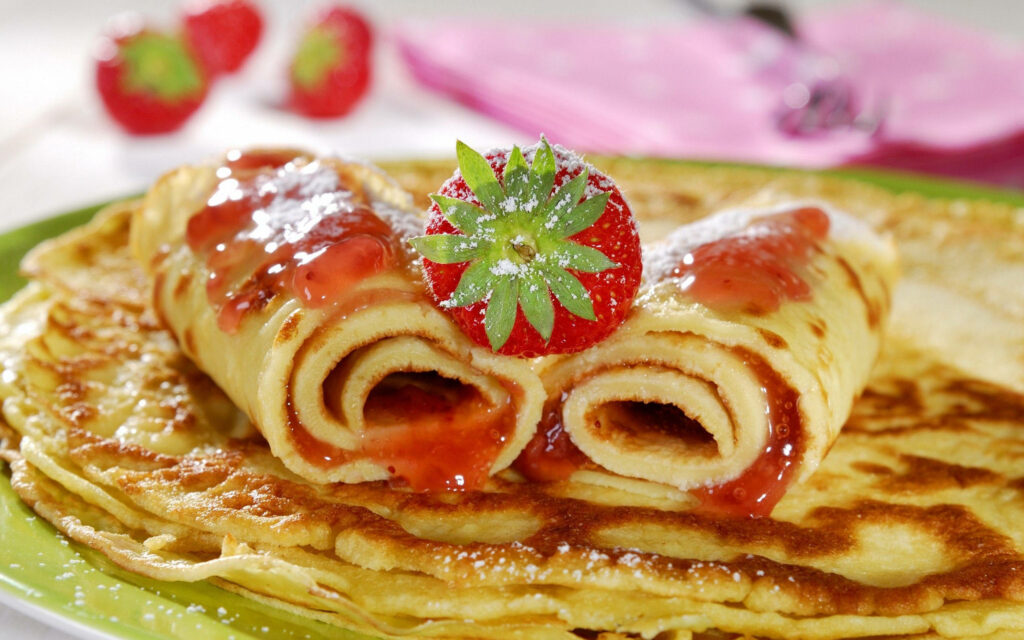 Stunning Crêpes Wallpaper: Golden Delights with Strawberry Jam