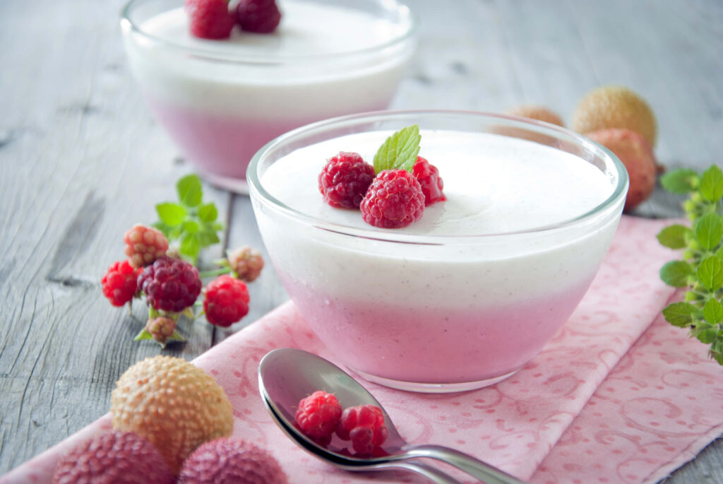 Sweet Indulgence: Tempting Yogurt Delight with Berries on a Pink Tablecloth Wallpaper