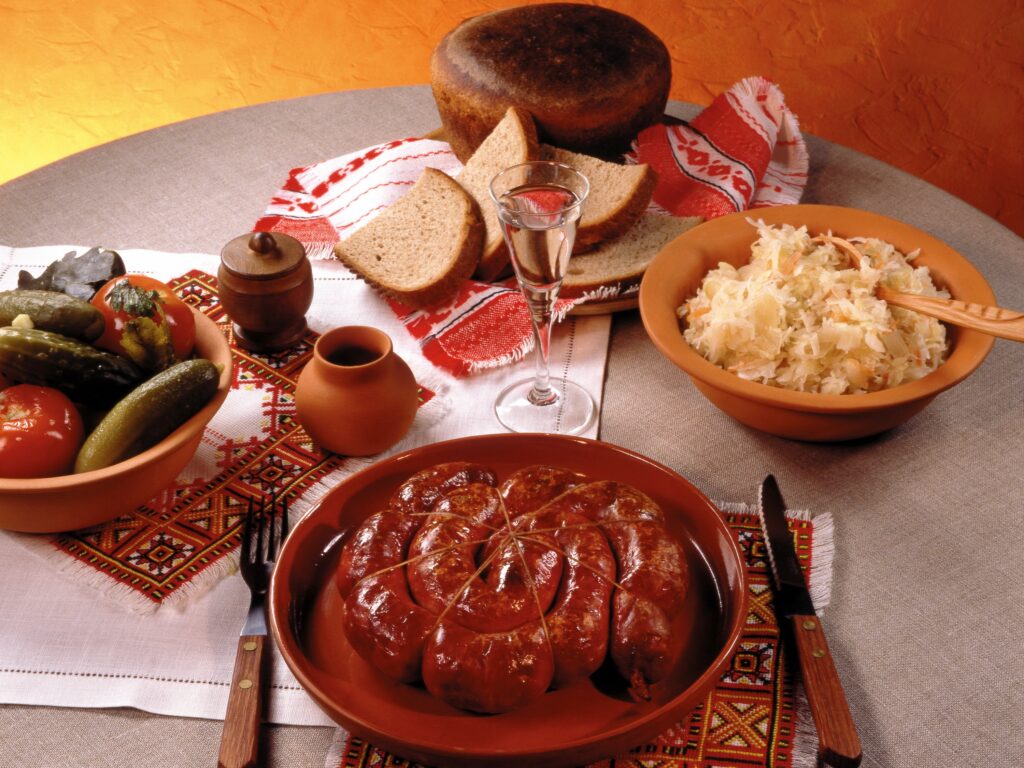 Delicious Dinner Spread Wallpaper: Meat, Bread, Pickles & Sauerkraut