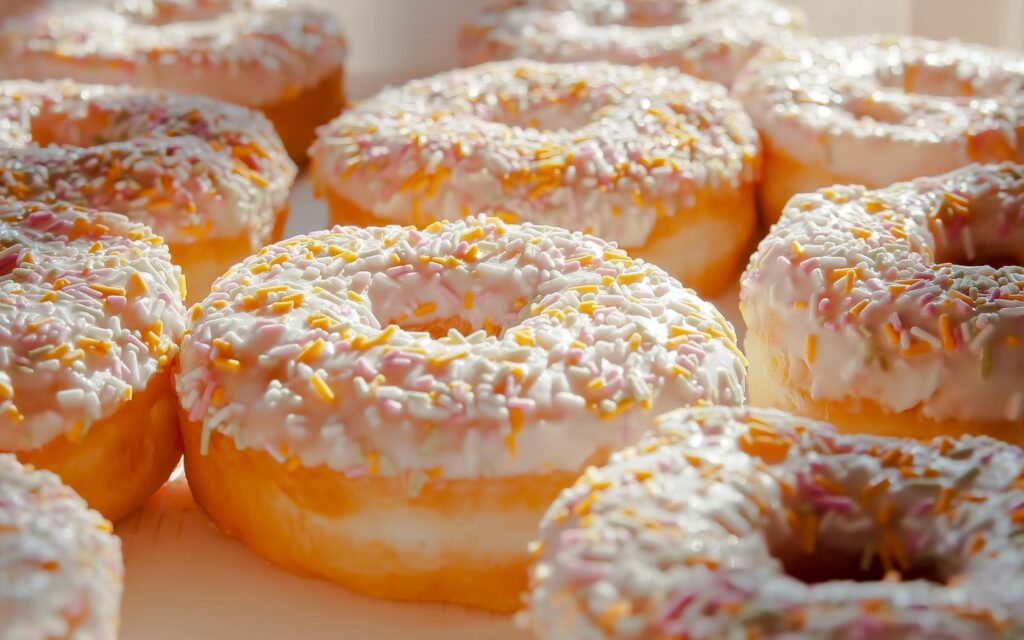 Delicious Donuts with Frosting & Sprinkles - Sweet Wallpaper Background
