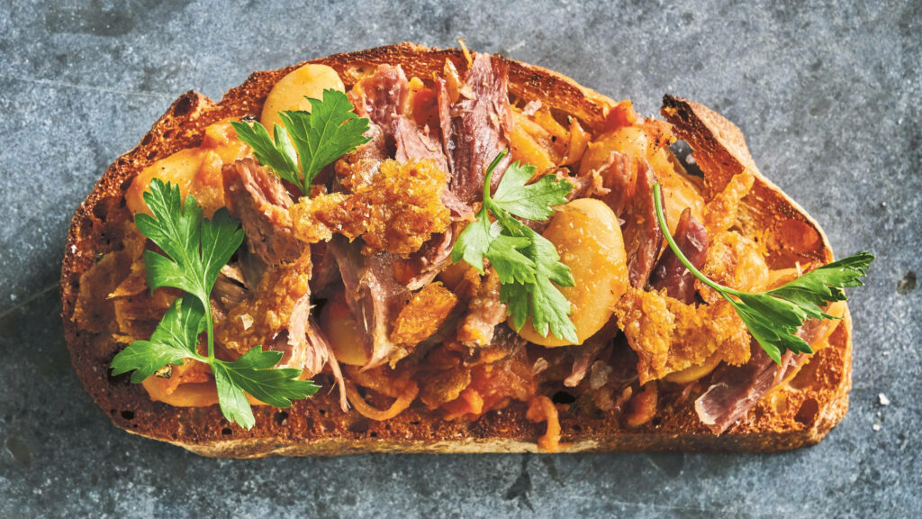 Decadent Duck Confit Cassoulet Toast Recipe | White Beans & Fresh Parsley Wallpaper