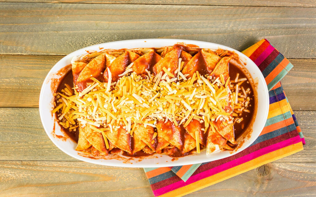 Delicious Enchilada Platter Wallpaper: Rustic & Cheesy Delight