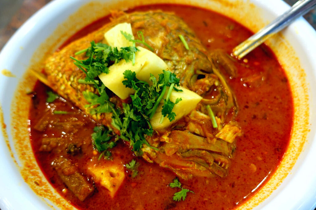 Vibrant Fish Head Curry in White Bowl - Stunning High-Angle Shot Wallpaper