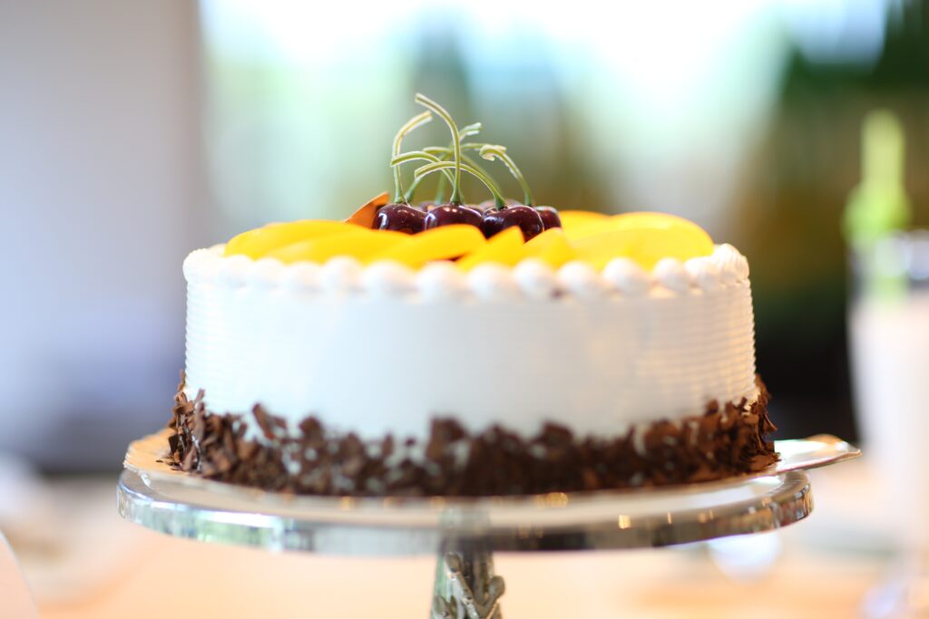Delightful Cake Decorated with Fresh Fruits & Chocolate for Celebrations Wallpaper