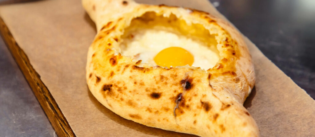 Golden Crust Khachapuri: Melted Cheese & Egg Wallpaper Background