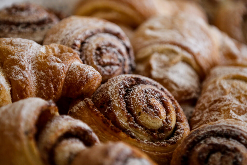 Golden Flaky Baked Pastries with Powdered Sugar - Wallpaper Background