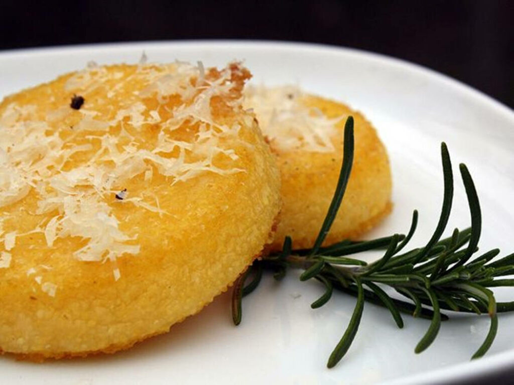 Golden Polenta Cakes with Cheese & Rosemary on White Plate Wallpaper