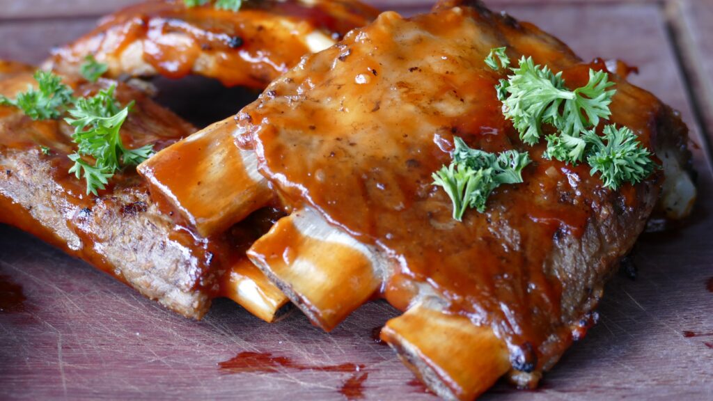 Delicious Grilled Barbecue Ribs with Savory Sauce & Fresh Parsley Wallpaper
