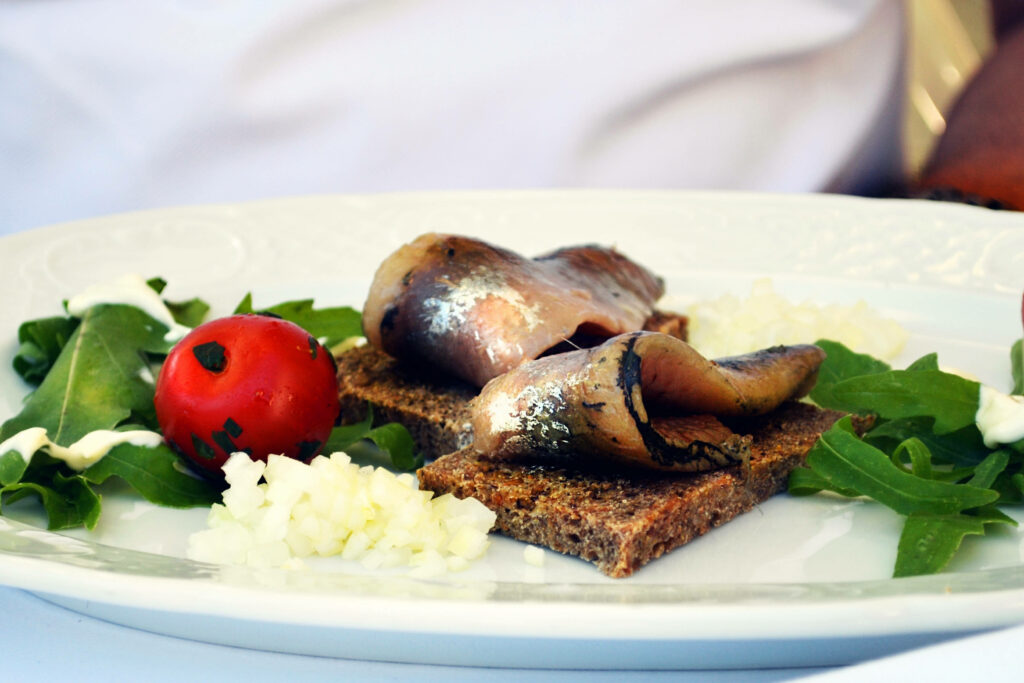 Elegant Grilled Boneless Herrings Wallpaper with Rye Bread & Greens