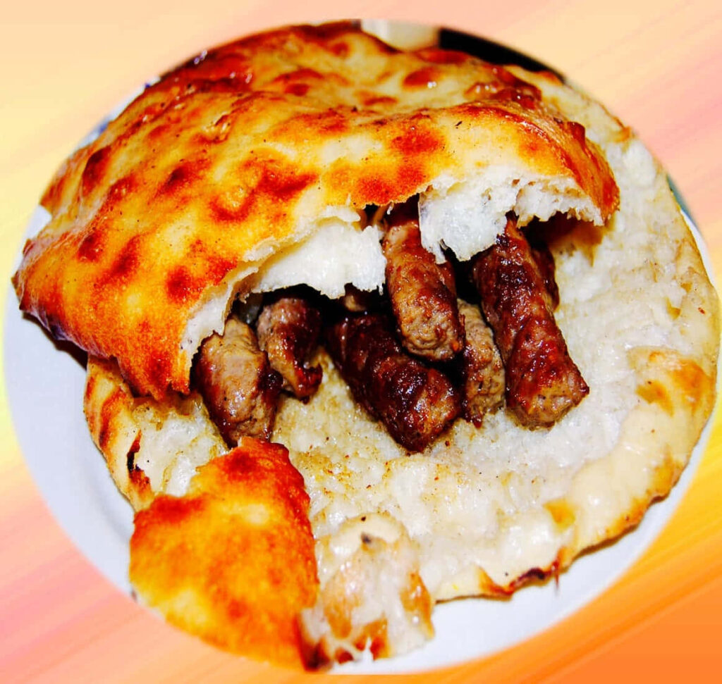 Delicious Grilled Ćevapi in Pita - Flavorful Wallpaper Background