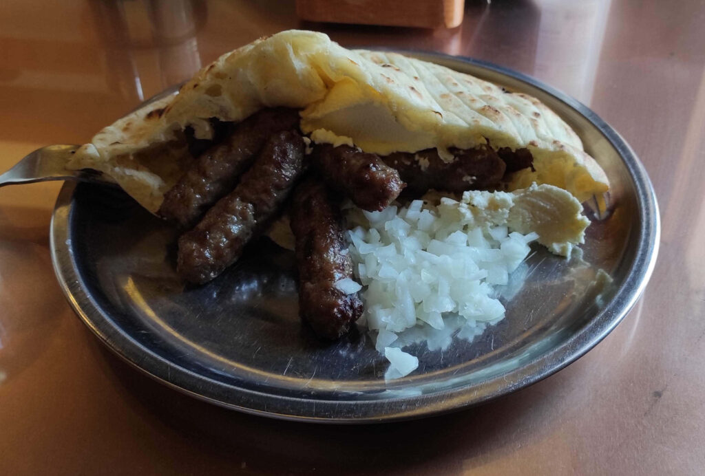 Delicious Grilled Ćevapi in Pita - Mouthwatering Wallpaper Background