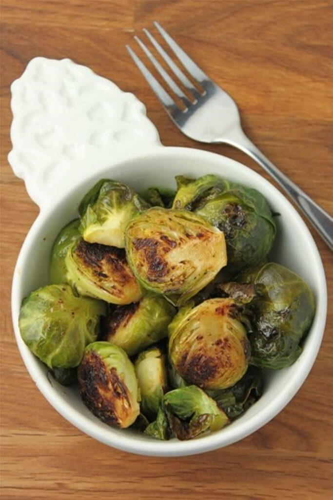 Honey Dijon Brussels Sprouts: Caramelized Delight on Wooden Surface Wallpaper