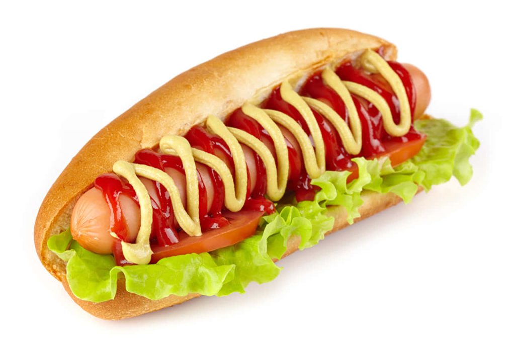 Close-up of a delicious hot dog with lettuce tomato ketchup and mustard in a soft bun wallpaper