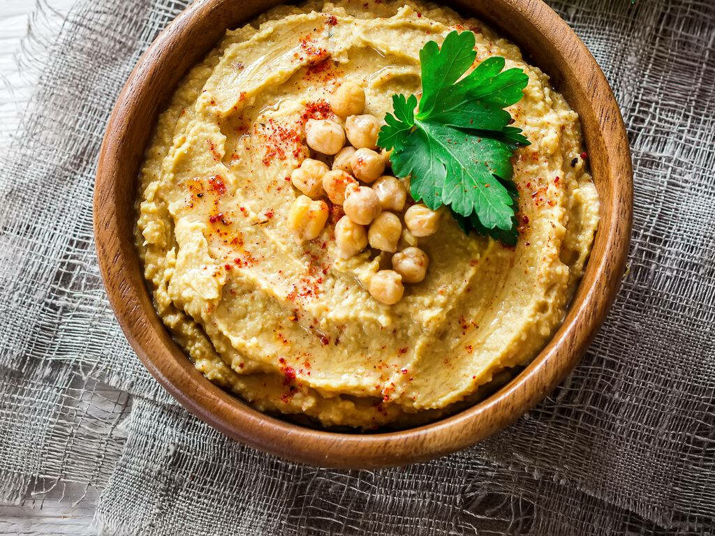 Delicious Hummus Bowl with Paprika & Chickpeas on Rustic Wallpaper