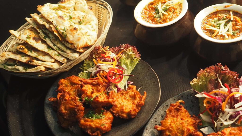 Delicious Indian Food Wallpaper: Pakoras, Curries, and Fresh Flatbread