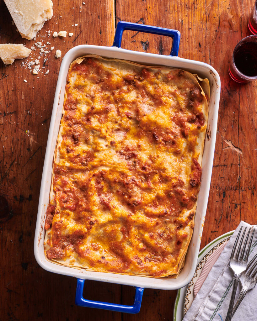 Rustic Lasagna Alla Bolognese Flat Lay with Wine & Utensils Wallpaper