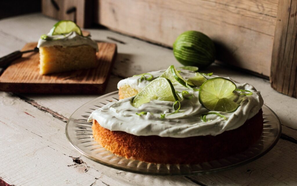 Delicious Lime Cake with Frosting & Fresh Lime Slices - Rustic Wallpaper