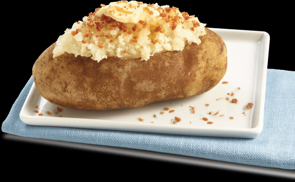 Delicious Loaded Baked Potato with Butter & Bacon on White Plate Wallpaper