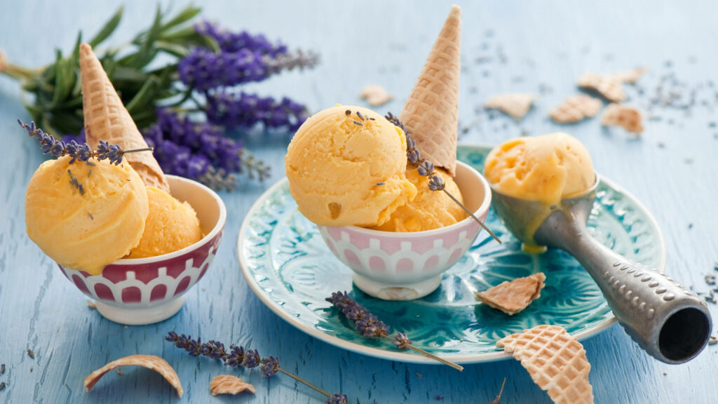 Taste of Summer: Mango Ice Cream Delights Cradled in Waffle Cones Wallpaper