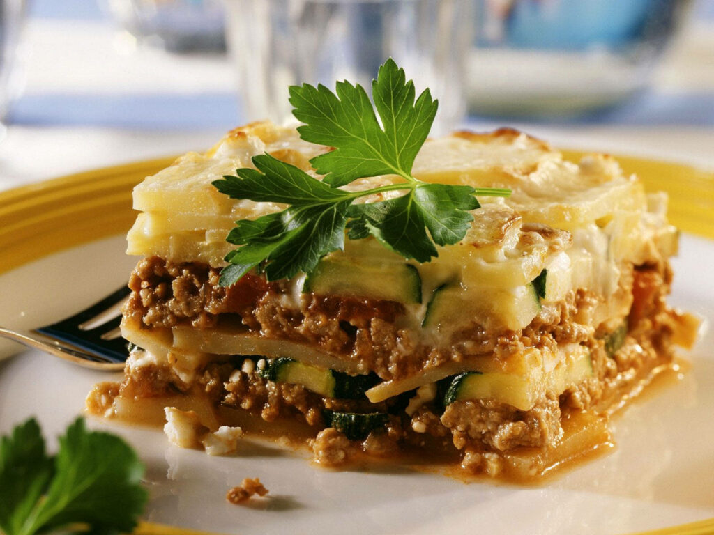 Delicious Moussaka Close-Up: Minced Meat, Veggies & Creamy Sauce Wallpaper