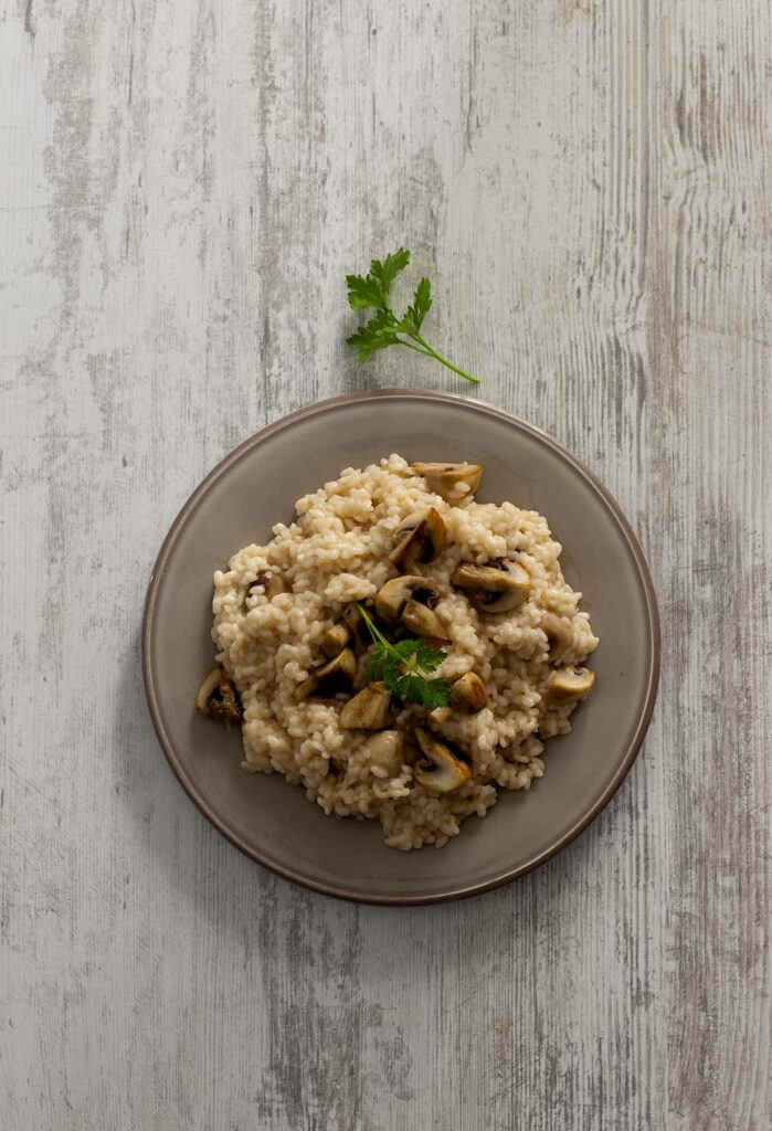 Rustic Wallpaper: Creamy Mushroom Risotto on Wood Background