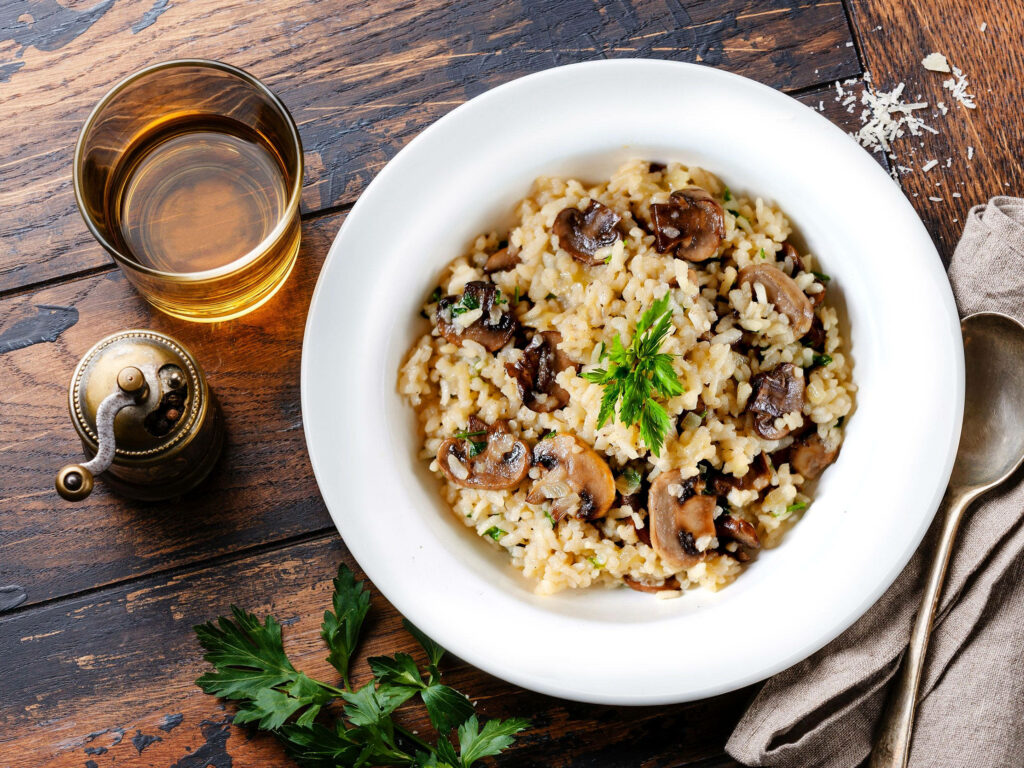 Delicious Mushroom Risotto with Herbs on Rustic Table - Wallpaper