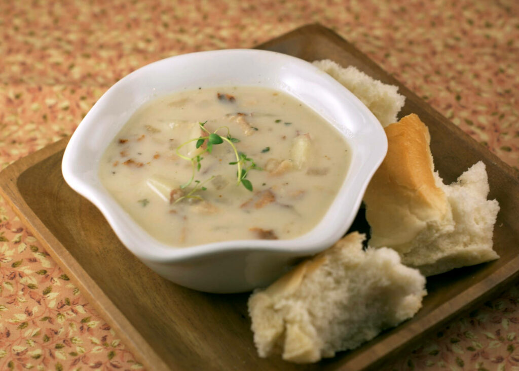 Cozy New England Clam Chowder & Fresh Bread on Rustic Tray Wallpaper