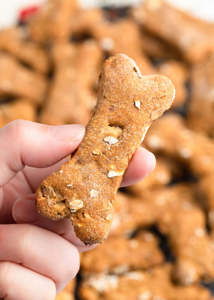 Nuts and Bones: A Close-Up of a Homemade Dog Treat Held by Human Hands Wallpaper