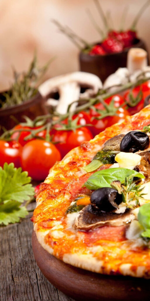 Delicious Olive & Basil Pizza on Rustic Table - Vibrant Ingredients Wallpaper