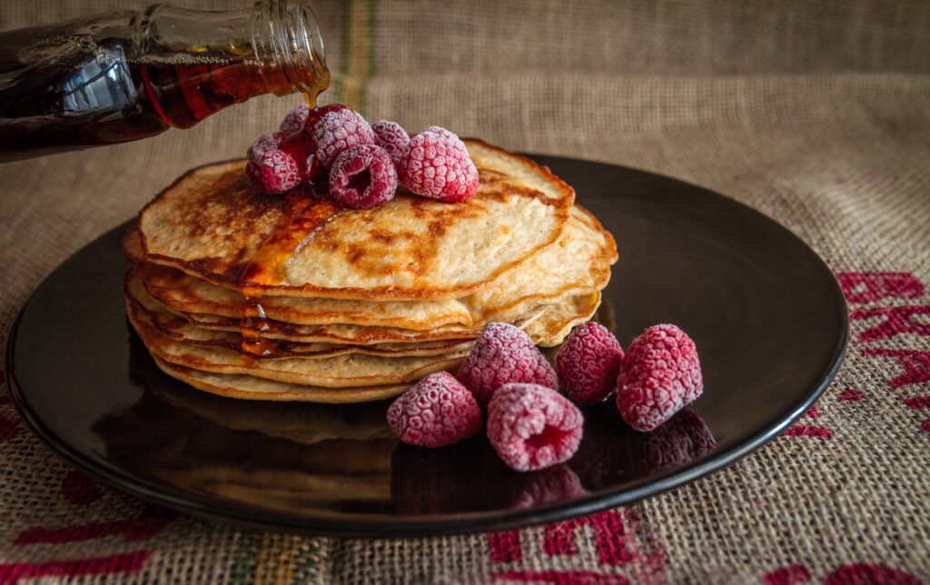 Golden Pancakes with Raspberries & Syrup - Delicious Wallpaper Background