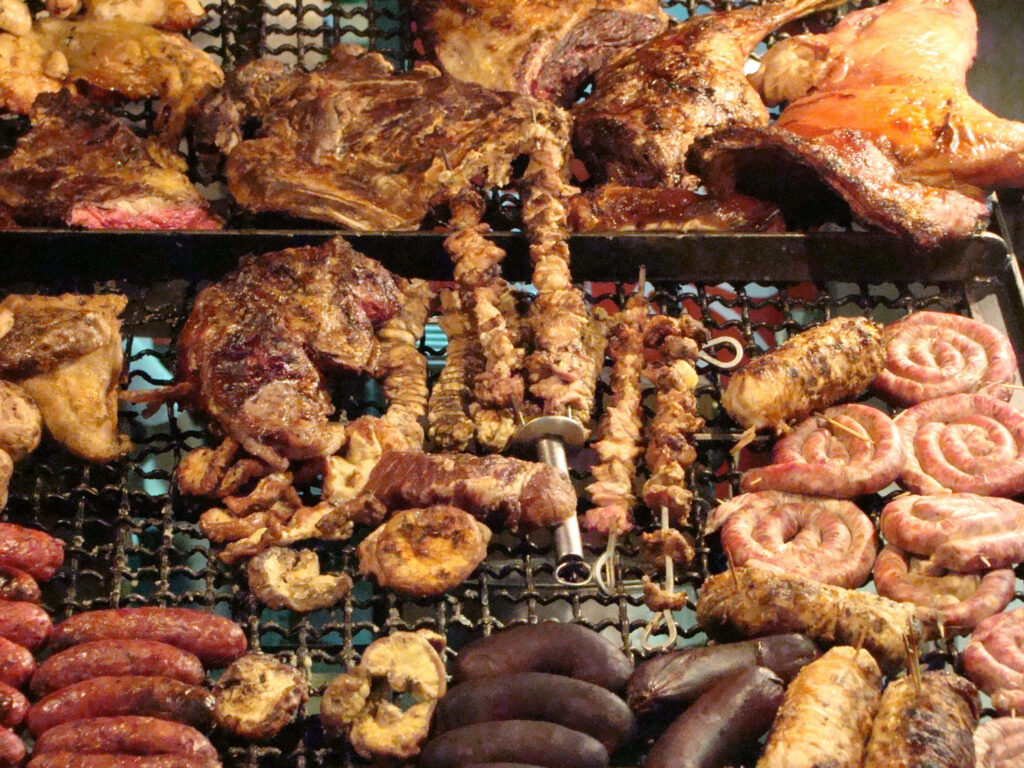 Savory Parrilla Wallpaper: Grilled Meats Over Open Flame Background