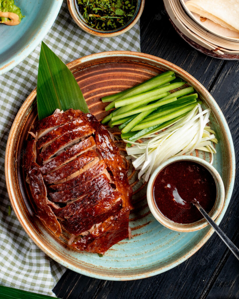 Delectable Peking Duck Wallpaper: Rustic Plate with Fresh Greens