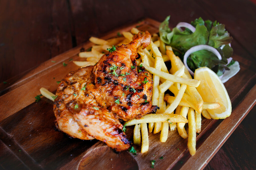 Delicious Peri Peri Chicken with Fries & Greens - Wallpaper Background