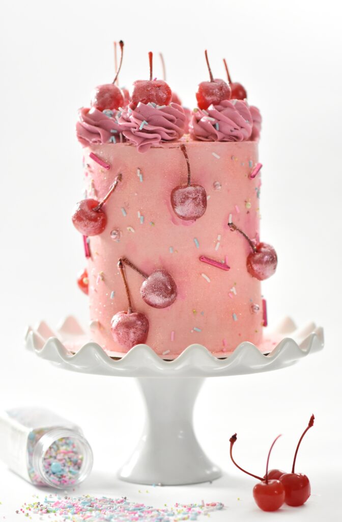 Delicious Pink Cake with Frosted Cherries & Sprinkles - Wallpaper