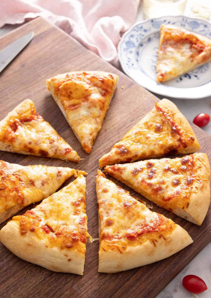 Close-Up of Delicious Pizza Slices: Golden Cheese & Crispy Crust Wallpaper