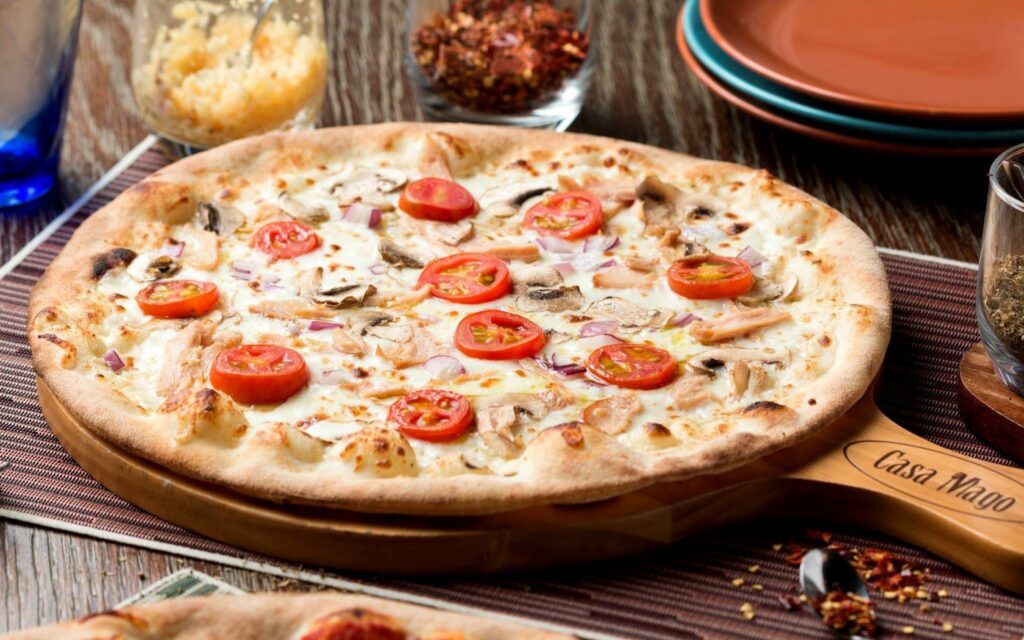 Delicious Pizza Wallpaper: Tasty Toppings & Rustic Table Setup