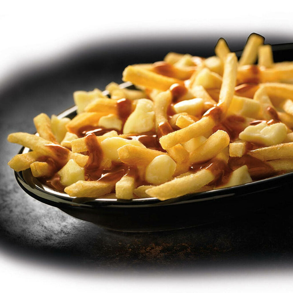 Close-Up of Savory Poutine: Fries, Cheese Curds & Gravy Wallpaper