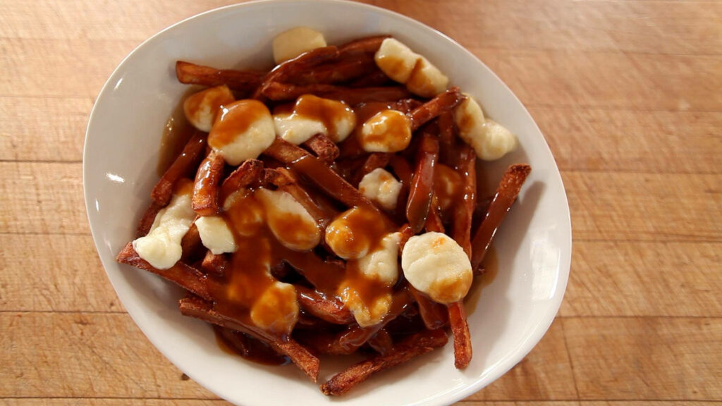 Delicious Poutine Wallpaper: Crispy Fries & Cheese Curds Background