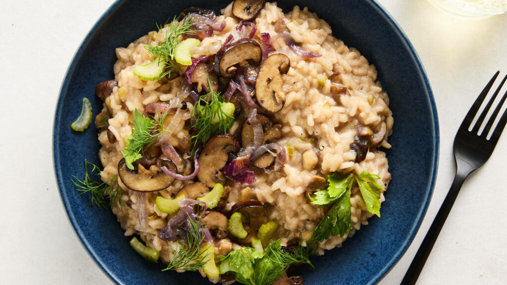 Delicious Risotto with Rosemary & Mushrooms in a Blue Bowl Wallpaper
